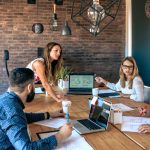 Female boss supervising work meeting